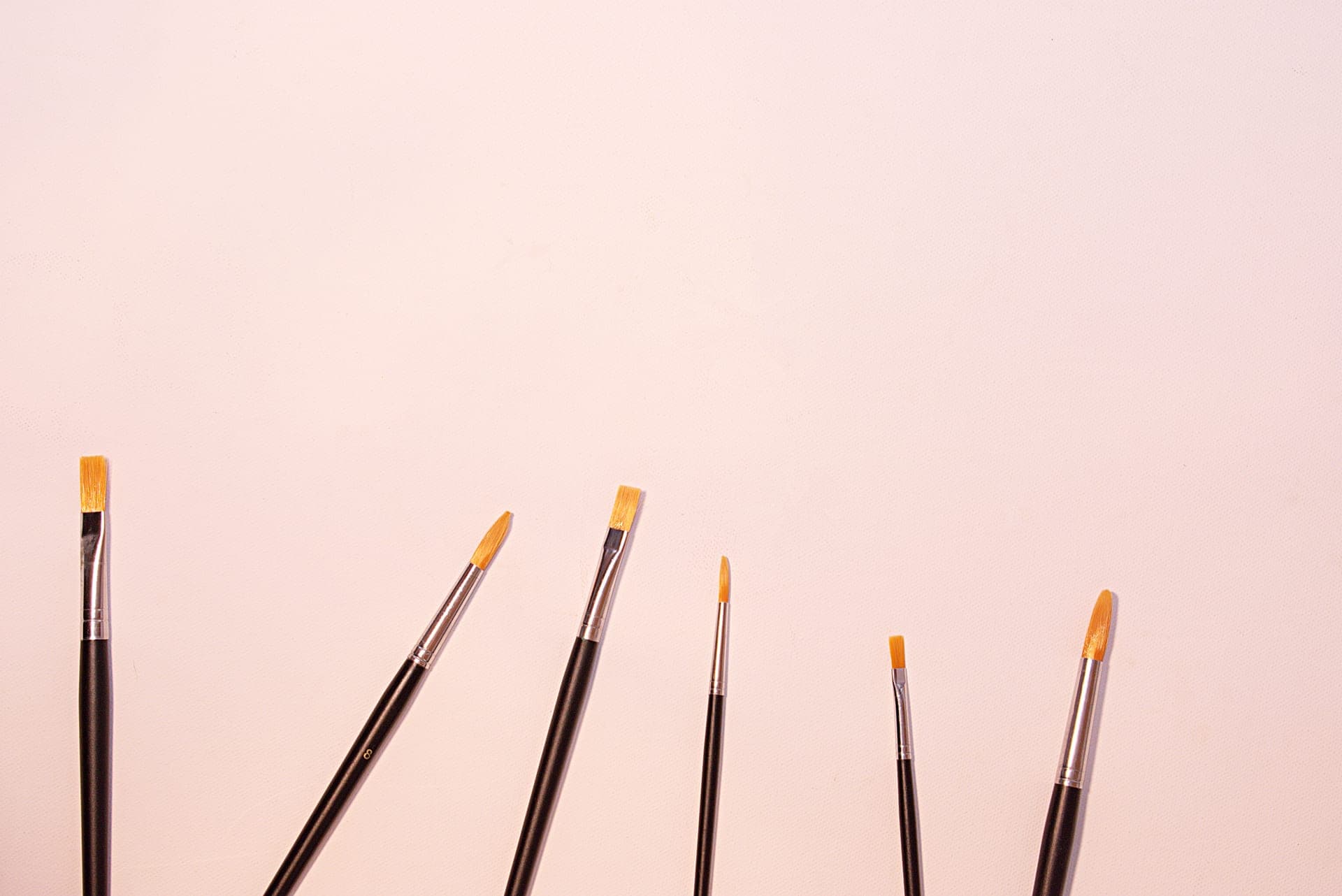 Round hair brushes of different sizes laid out on a surface
