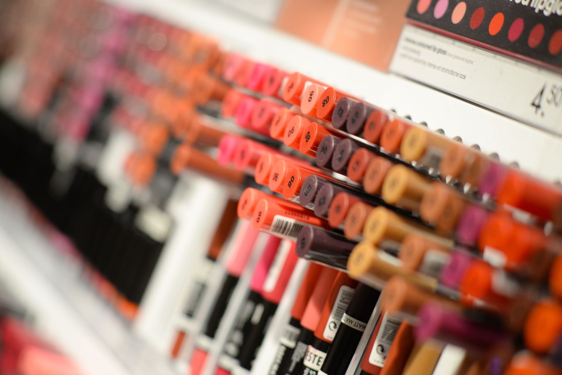 A drugstore beauty aisle shelf stocked with styling products