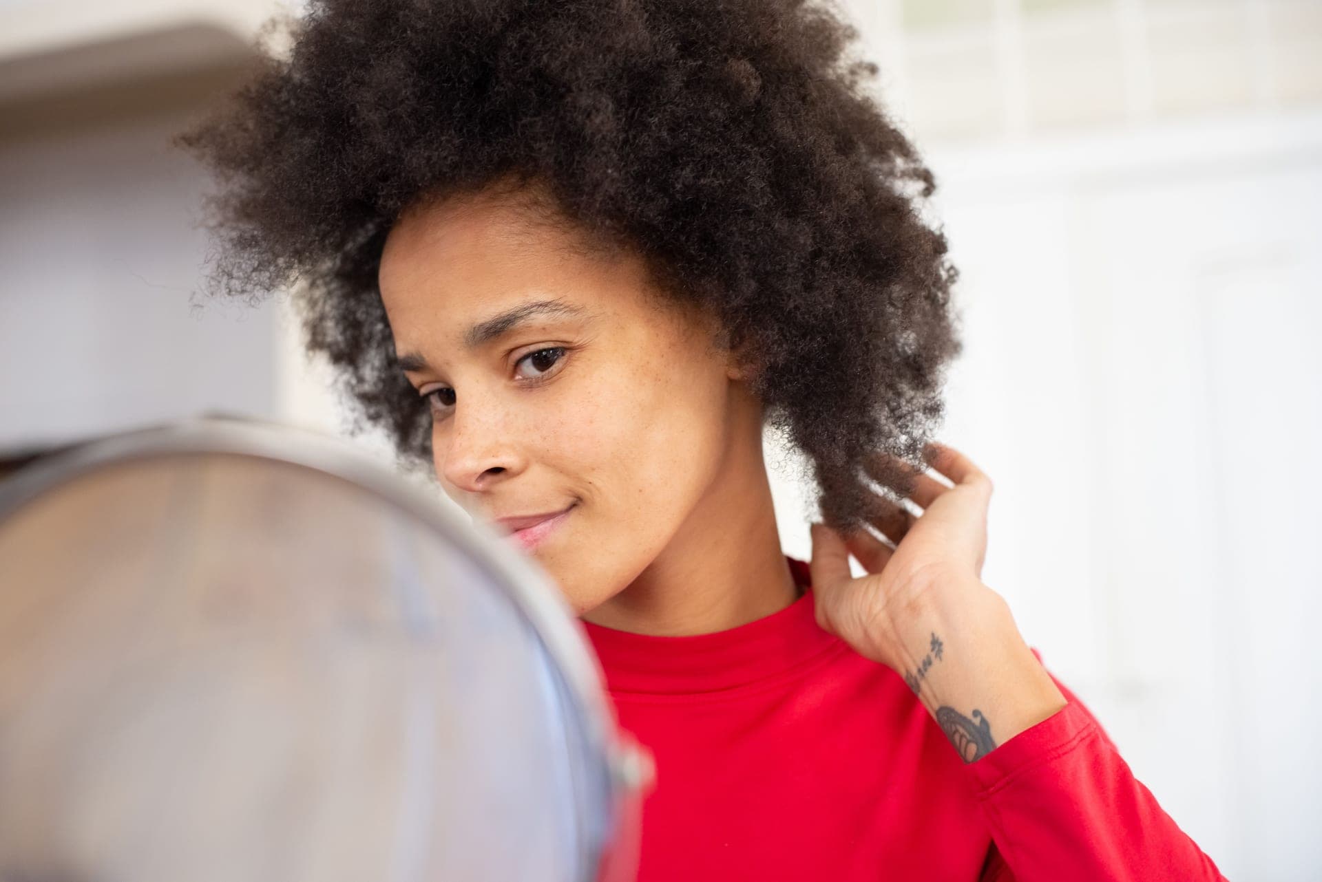 Close view of coily 4C natural hair texture in daylight