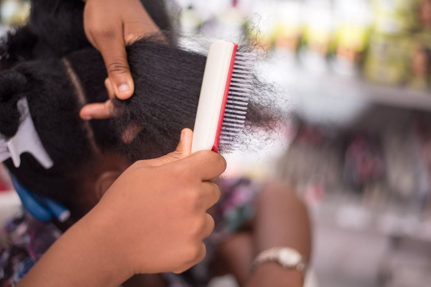 A detangling brush resting on a pale surface