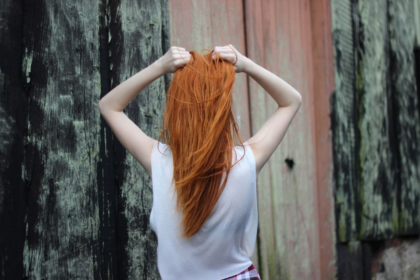 Very long hair falling down a back in daylight
