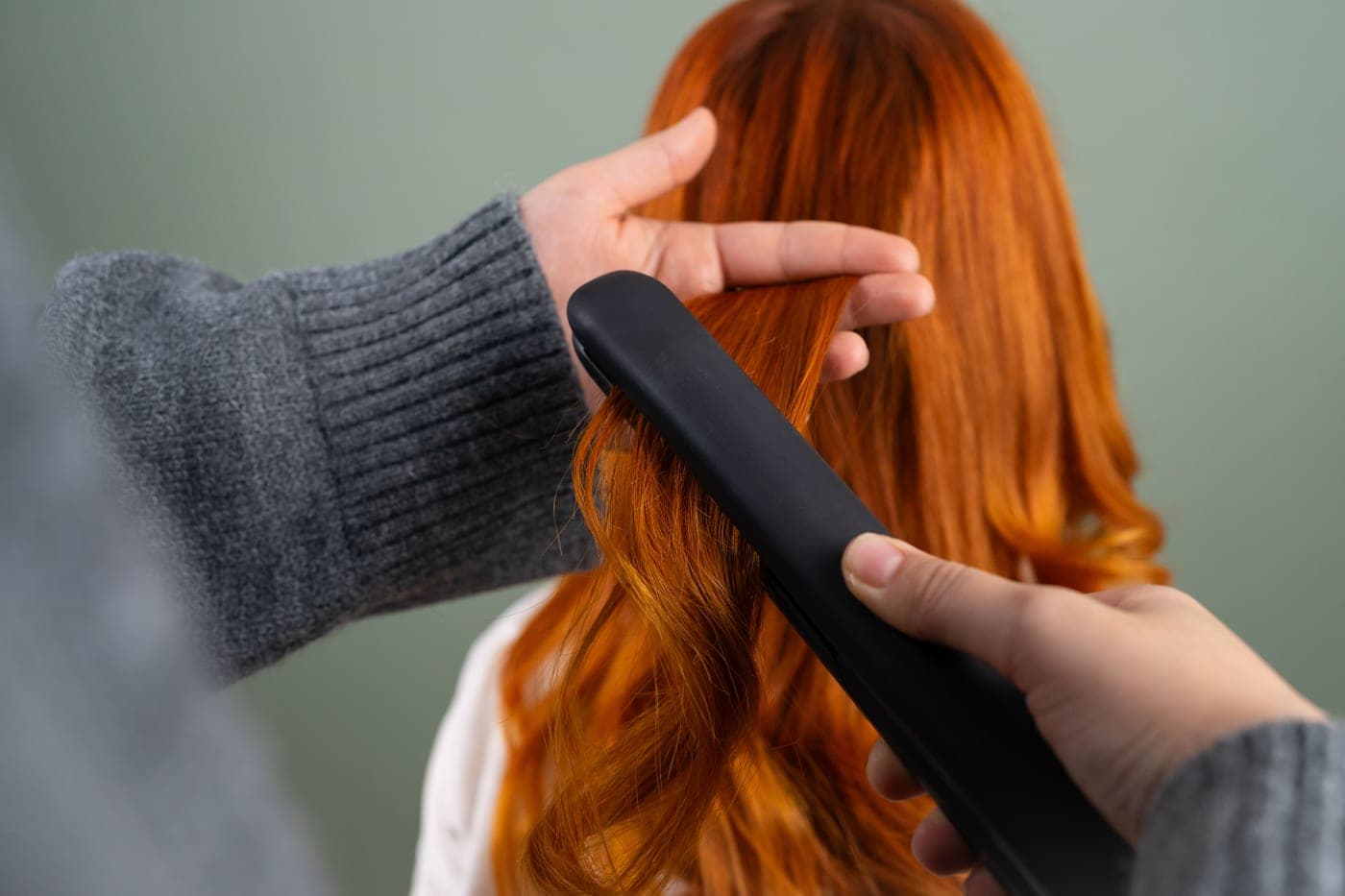 Long hair being straightened section by section
