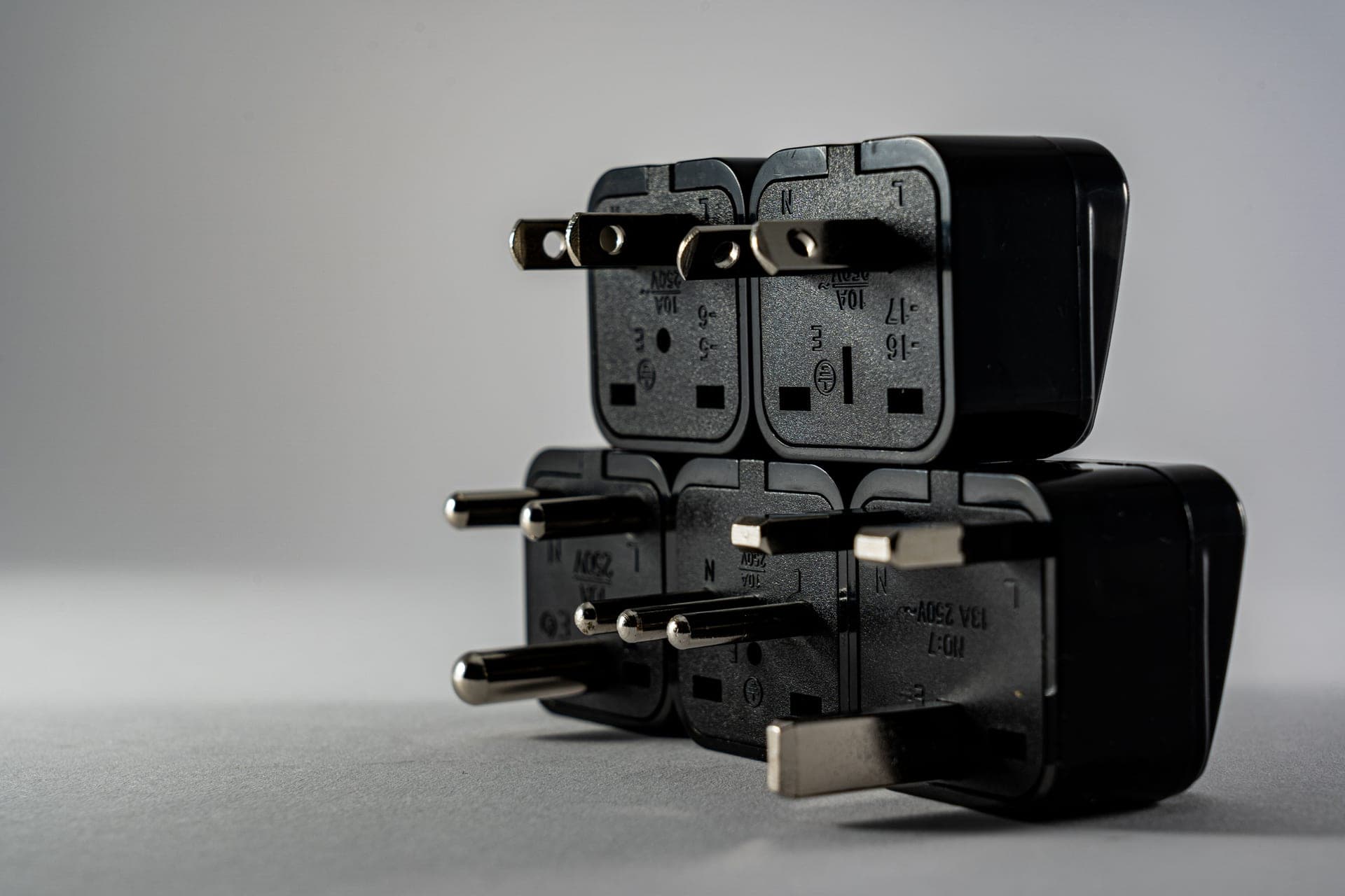 A travel plug adapter beside a passport