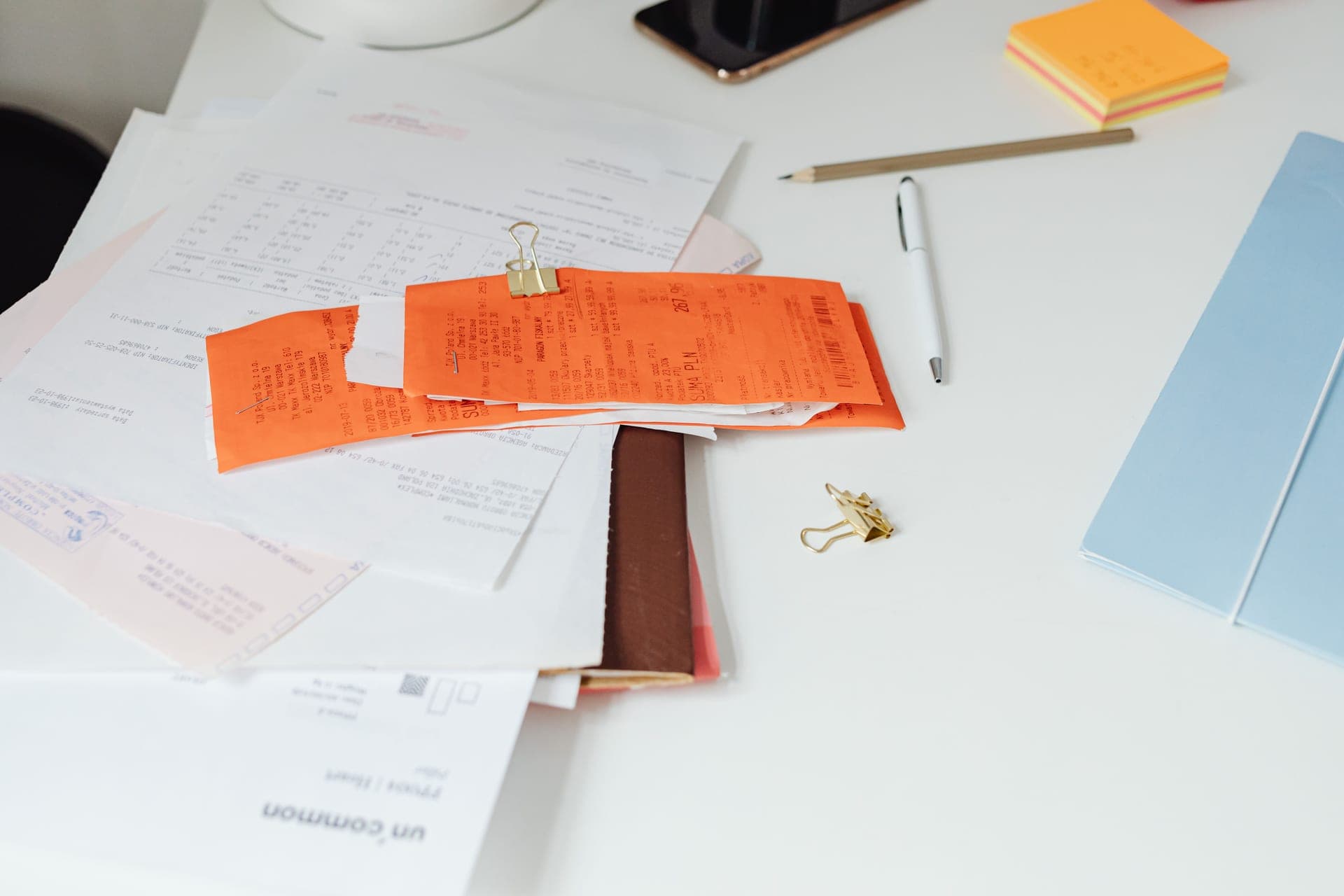Warranty paperwork and a receipt on a desk